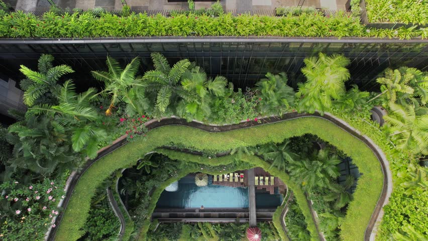 Aerial view of the famous hotel in Singapore. This building has a jungle like green facade. Royalty-Free Stock Footage #1103478975
