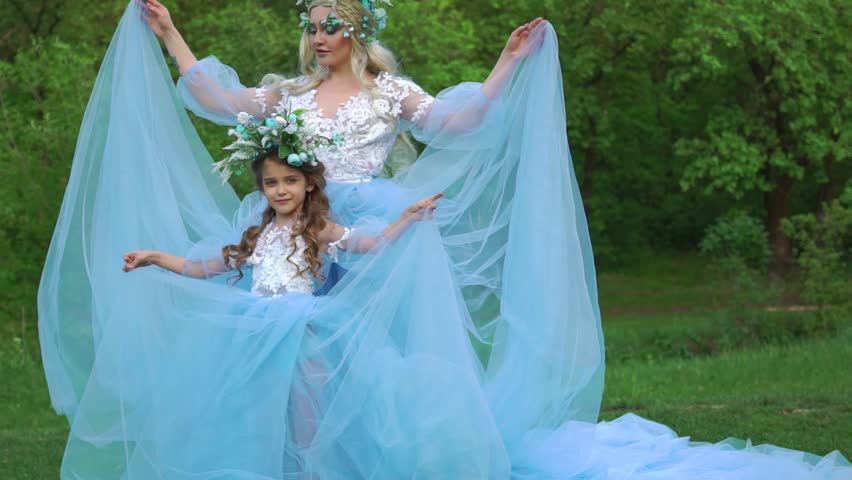 Slow Motion Two beautiful princess girls in luxurious dresses with a long train.