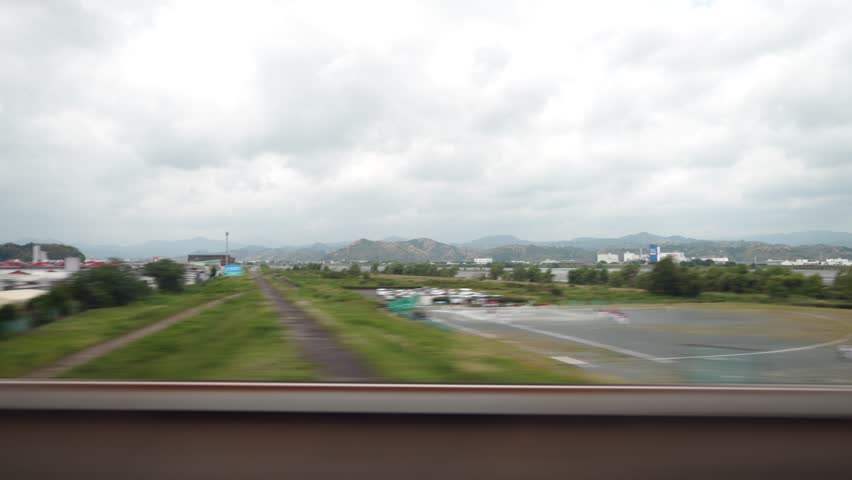 View of a suburban area from the window of the Shinkansen Bullet Train, Japan's high speed train. Traveling in the direction of Tokyo. 