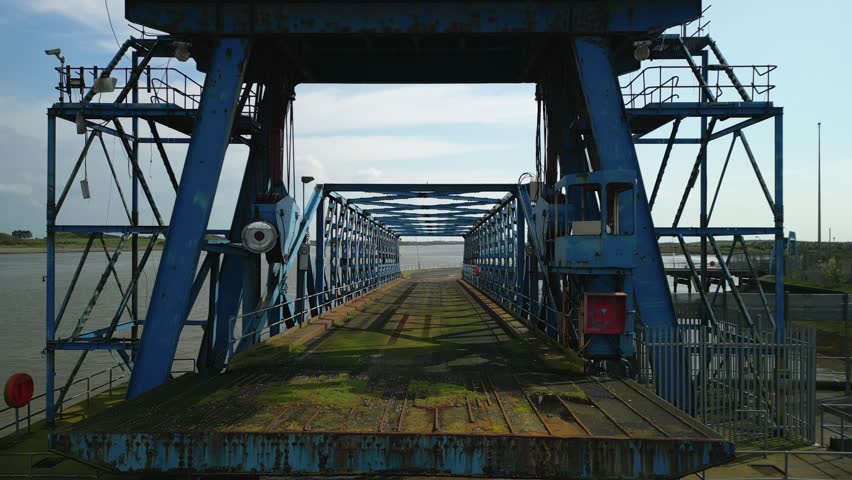 Flying under derelict crane and into rusted bridge on abandoned docks at Fleetwood Docks Lancashire UK