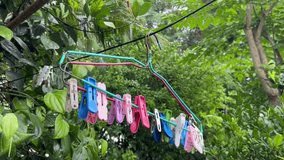 
Clothes hangers with colorful clips blown gently by the wind.