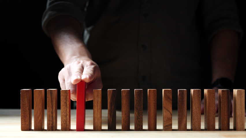 Businessman hand stopping wooden domino business crisis effect or risk protection on dark background. Concept of Risk, Risk Management, Assessment, Business, Crisis, Financial, Planning, Economic Royalty-Free Stock Footage #1103485187