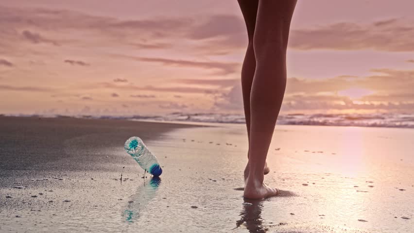 Environment Pollution by Woman Throwing Plastic Bottle at Beach Close-up. Rising Issue of Refuse and Waste in Clean Tropical Water. Messy Female Going and Dropping Trash Outdoors Harming Nature Zone