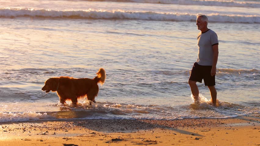 64 year old man getting his exercise at the beach at sunset. Slow Motion.
