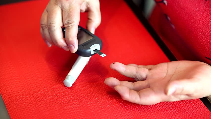 Patient Diabetes Measuring Glucose Level With Glucometer. Finger Prick Blood Sugar Monitoring.Diabetes Glycemic Control  Meal Planning. Self Care Hematocrit Level Measure. Diabetes Hyperglycemia Risk 