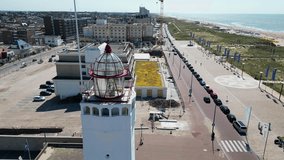 This aerial drone video shows the white lighthouse in Noordwijk. This lighthouse is a landmark on the famous boulevard of this small town in the Netherlands. 