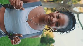 VERTICAL VIDEO, Smiling young woman looking at camera