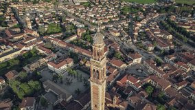 Stunning aerial footage of Santa Sofia Bell Tower in Lendinara during a captivating sunset.