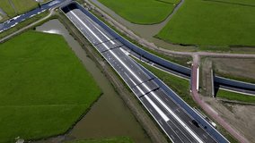 This aerial drone video shows the roadworks of a new highway, N434 in Leiden, the Netherlands. This highway is partly a tunnel and is surrounded by meadows. 