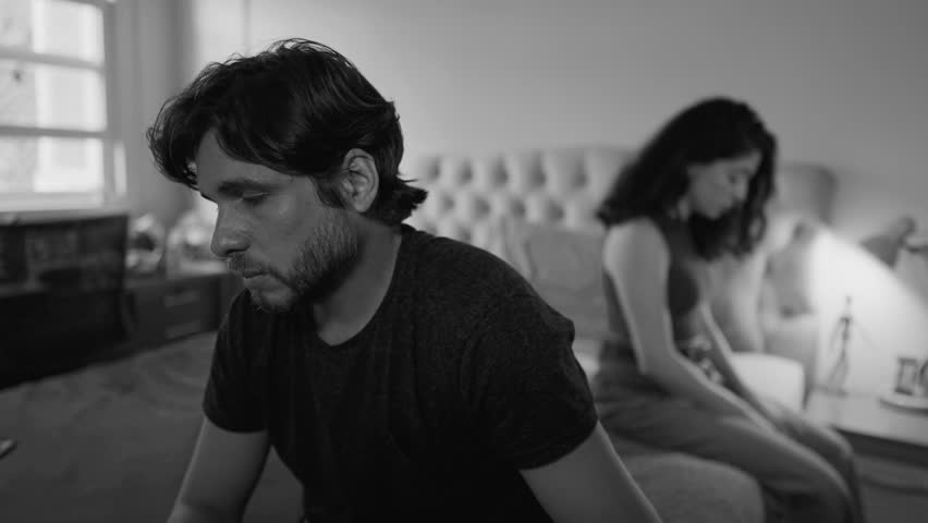 Desperate couple going through difficult times. Unhappy relationship breakdown. People suffering from a bad marriage in dramatic monochromatic black and white | Shutterstock HD Video #1103494887