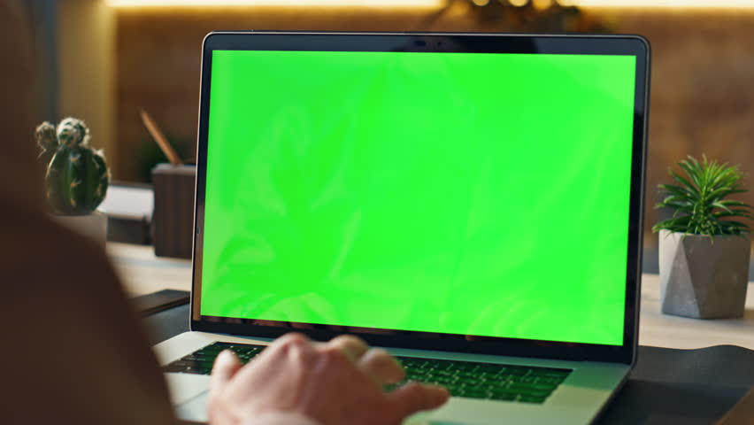 Unrecognizable person using mockup laptop working remotely at home close up. Manager hands scrolling touchpad surfing in internet looking information online. Worker touching chroma key computer pad.