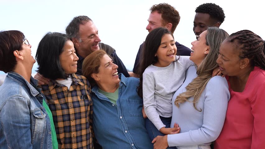 Group of multigenerational people hugging each other while smiling in front of camera - Multiracial friends having fun together outdoor Royalty-Free Stock Footage #1103497297
