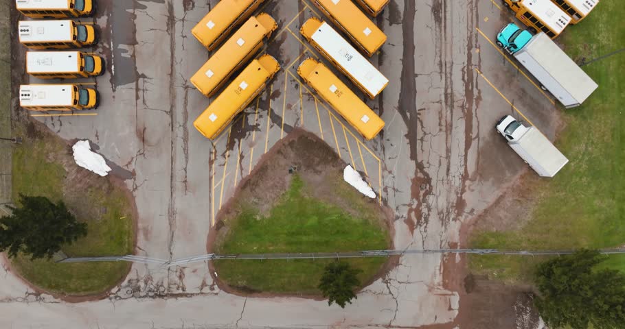 Aerial video of rows of parked school buses
