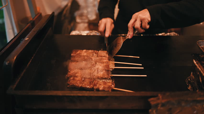 Japanese street food vendor cooking wagyu beef grill skewers.

 Royalty-Free Stock Footage #1103504443
