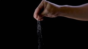 Man's hands are sprinkling salt on food on a black background	 - Powered by Shutterstock - Get 15% off with code: PIKWIZARD15