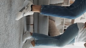 Vertical video. Enjoying life. Family joy. Funny entertainment. Unrecognizable man and two women dancing jumping all together in light home interior. - Powered by Shutterstock - Get 15% off with code: PIKWIZARD15