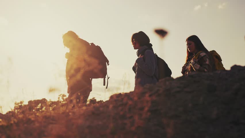 Business. group of climbers walk go through the mountains silhouette. business journey travel concept. hikers walk silhouette at sunset. climbers team lifestyle with backpacks | Shutterstock HD Video #1103512683