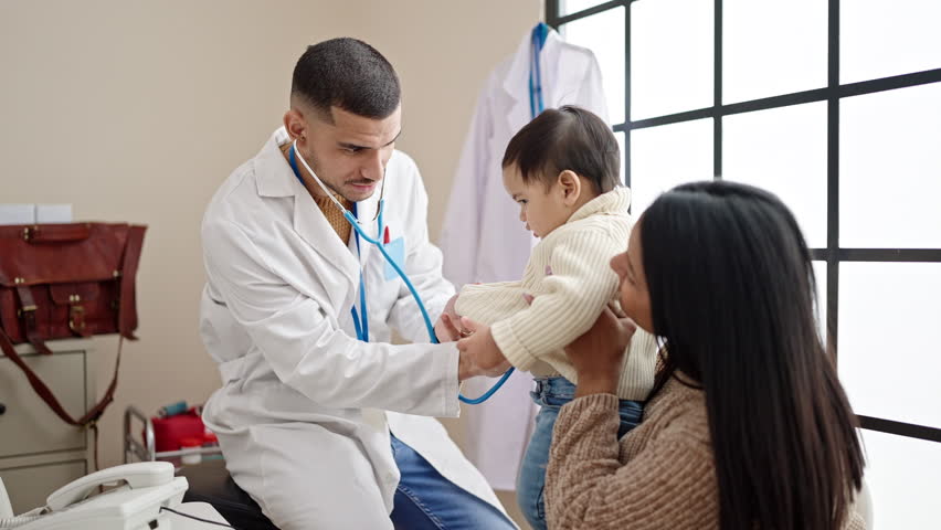 Couple and son examining baby with stethoscope at clinic Royalty-Free Stock Footage #1103514199