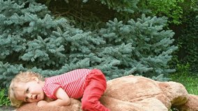 Happy little child having fun jumping on his giant teddy bear - Powered by Shutterstock - Get 15% off with code: PIKWIZARD15
