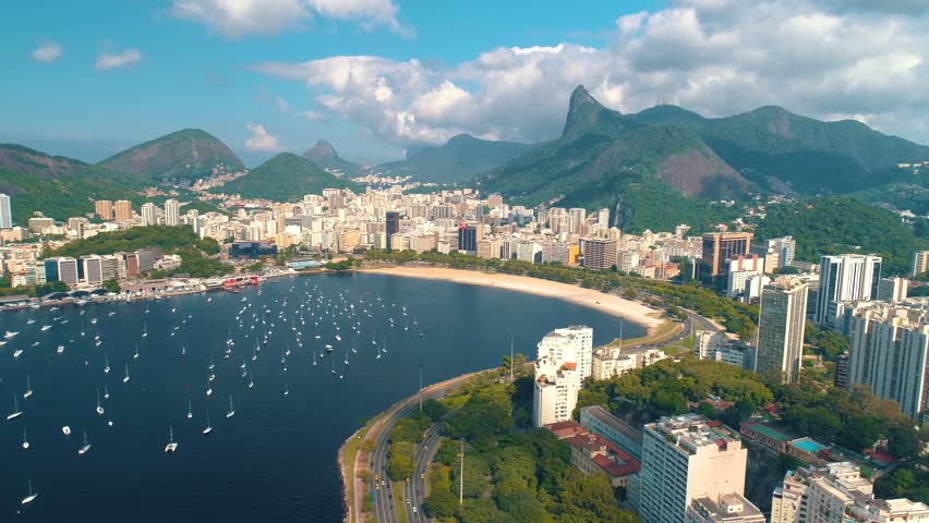 RIO DE JANEIRO, BRASIL - MAY, 2023: Drone aerial view of of Botafogo beach and district and Guanabara Bay. Modern and historical buildings on the shore on background at sunny day from above.