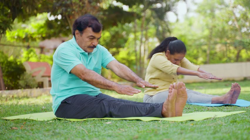 Indain senior couple at morning doing yoga at park - concept of healthy active lifestyle, outdoor fitness and wellness Royalty-Free Stock Footage #1103525087