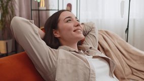 Portrait of tired young woman enjoy relaxing on home couch in room. Happy pretty girl lying on couch resting napping after hard working day, closed her eyes, put hands behind head, stress free, rest - Powered by Shutterstock - Get 15% off with code: PIKWIZARD15