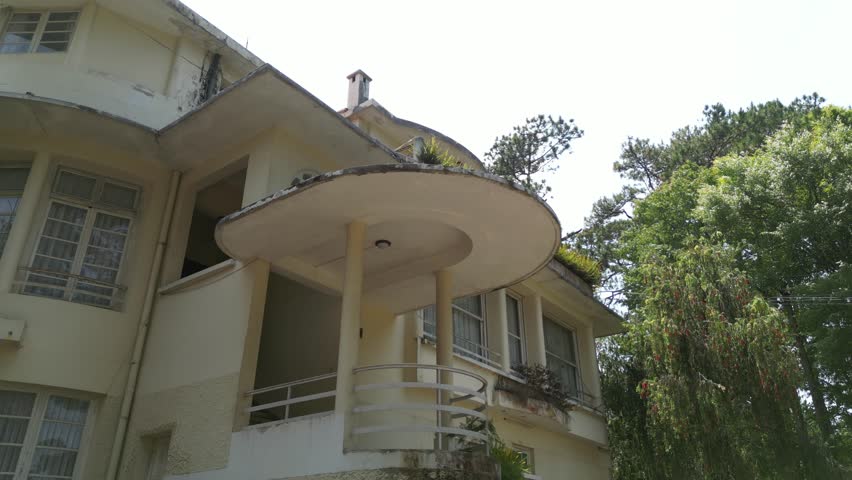 Drone footage along a beautiful old building transformed now in hotel on a hill in Dalat city , south Vietnam 1-2