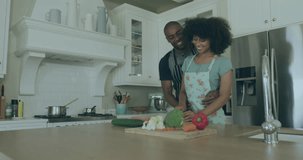 Animation of data processing over african american couple preparing dinner in kitchen. Lifestyle, computing and digital interface concept digitally generated video.