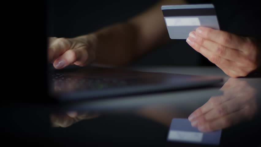 Lateral Dolly Close up of Young Woman Hand typing Credit Card Pin to Pay Online on Computer Laptop, Dark Room. Online Purchase Ecommerce Website Payments Concept. Blurred data. Royalty-Free Stock Footage #1103536699