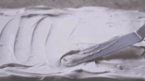 macro video of pastry spatula zigzagging through fresh meringue, satisfying video, selective focus