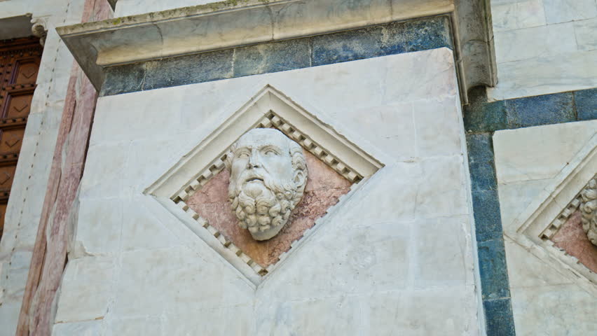 Unique and beautiful Siena Cathedral in Italy, close up view of the architecture. Facade of Duomo di Siena Cathedral with marble stripes in symbolic black and white.