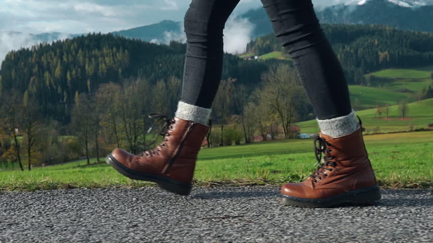 Man Walks along the Mountains to the Top. Tourist in Boots Going along the Stone Road on the Background a Beautiful Landscape. Travel Concept Active People on the Way to Victory Move Forward Close Up Royalty-Free Stock Footage #1103543005