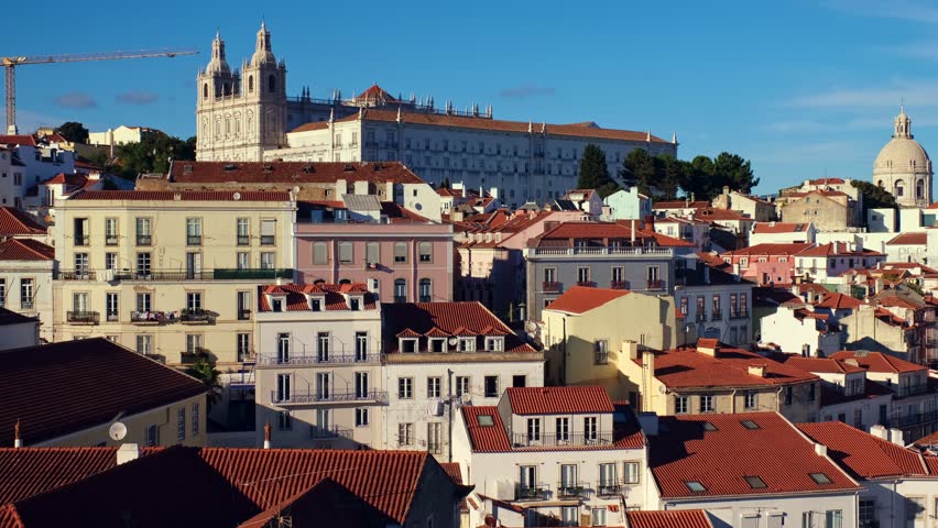 Lisbon famous view from Miradouro de Santa Luzia tourist viewpoint over Alfama old city district, cruise liner and moving clouds. Lisbon, Portugal. Camera pan