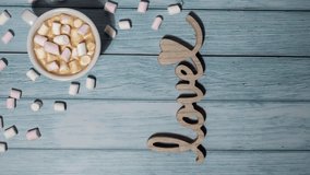 Vertical Zoom in out Wooden word love with heart romance with white coffee cup of hot chocolate and small marshmallows. Minimal concept of greeting card for Valentine's Day, Mother's Day, Women's Day - Powered by Shutterstock - Get 15% off with code: PIKWIZARD15