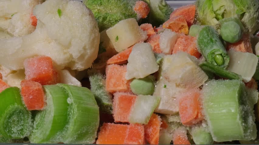 Time lapse of melting Frozen mixed vegetables for long-term storage. Deep freezing of vegetables. defrosting Frozen food background Royalty-Free Stock Footage #1103548849