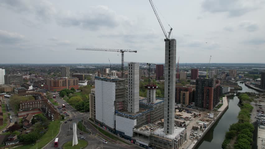 Rising drone aerial high rise apartments building site Stratford East London UK