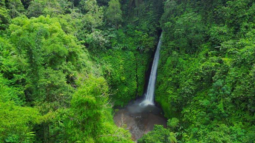 Air Terjun Melanting Waterfall. There are almost 500 steps to get to the waterfall. You don’t have to worry about safety on the stairs, but they can be a little steep.	 Royalty-Free Stock Footage #1103566097