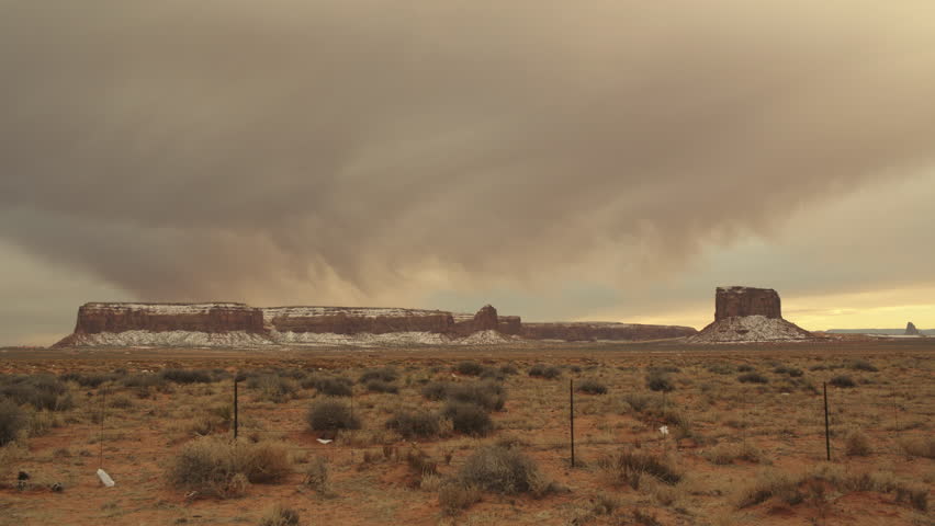 A timelapse of a beautiful Arizona desert sunset as clouds roll by and the sun lights up the rock formations just before it dips below the horizon