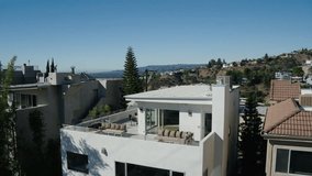 Aerial Tilt Down Shot Of Houses On Hill In City During Sunny Day, Drone Ascending Over Residential Structures - Los Angeles, California - Powered by Shutterstock - Get 15% off with code: PIKWIZARD15
