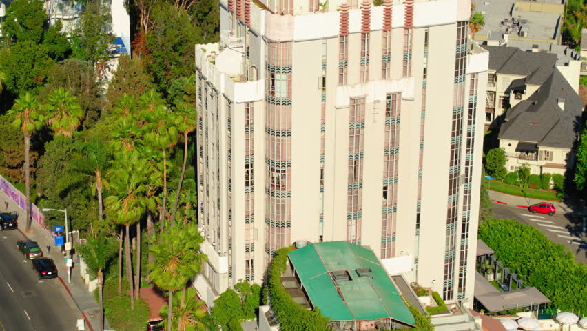 Aerial Upward Shot Of Tower And Houses By Trees On Sunny Day In City - Los Angeles, California