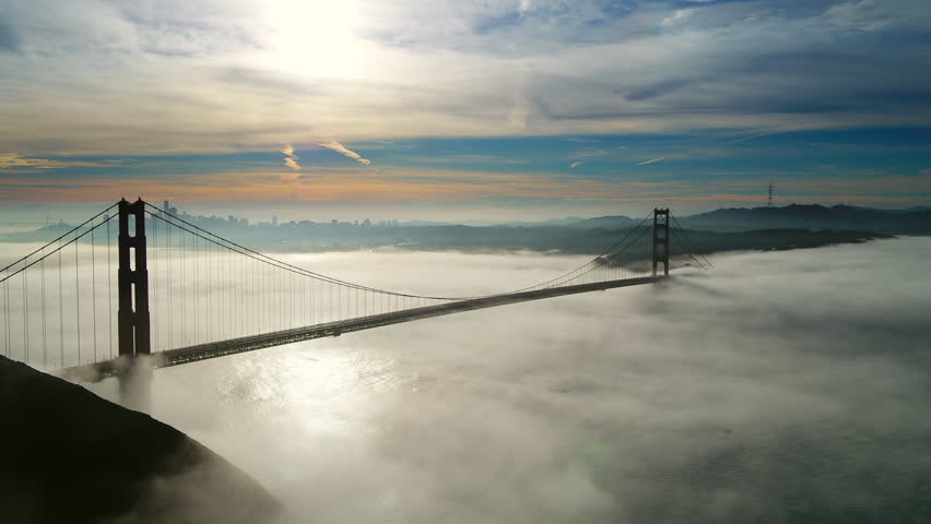 Aerial Lockdown Shot Of Golden Gate Bridge Over Sea Against Cloudy Sky, Drone Flying Near Famous Landmark And City At Sunset - San Francisco, California