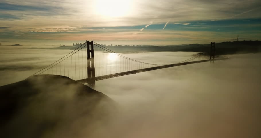 Aerial Panning Shot Of Famous Golden Gate Bridge On Sea Near City, Drone Flying Under Foggy Weather At Sunset - San Francisco, California Royalty-Free Stock Footage #1103570539