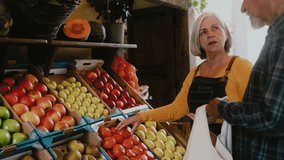 Senior man buying fruits and vegetables - Mature greengrocer help a client with the purchase at the market - Shopping food concept - Powered by Shutterstock - Get 15% off with code: PIKWIZARD15