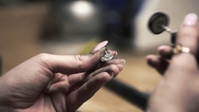 Close up shot of a female metalworking jeweller using a sanding machine to polish a silver metal necklace. Shot in a jewellers on the Isle of Lewis, part of the Outer Hebrides of Scotland. - Powered by Shutterstock - Get 15% off with code: PIKWIZARD15