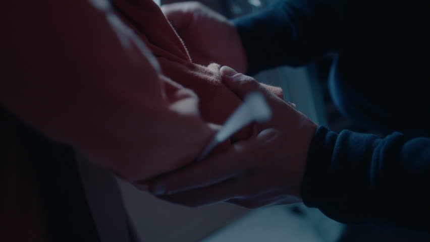 Criminal tying hands of victim with plastic cable tie, going to commit murder or physical violence in dark garage at night. Close-up shot Royalty-Free Stock Footage #1103589999