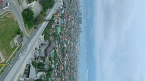 view overlooking the town. mountains, cars. vertical video