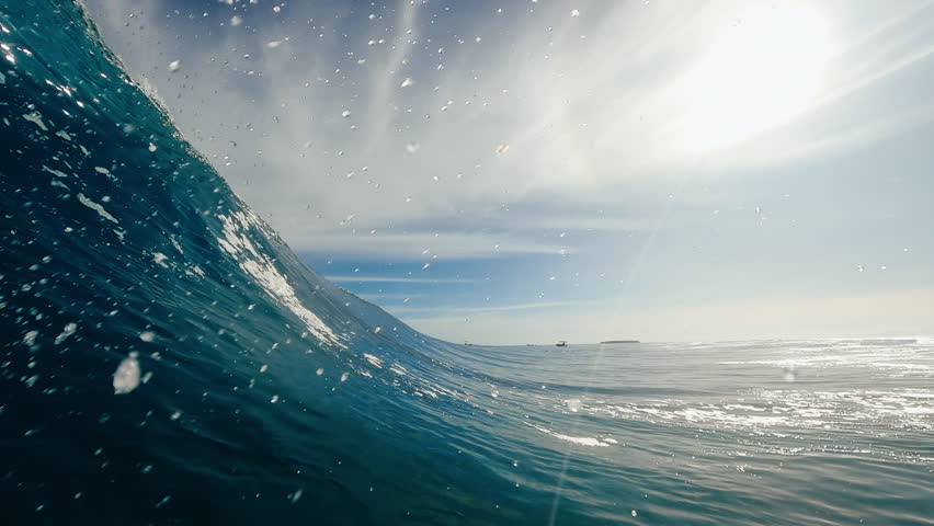 POV view from inside the tube of surfer riding perfect blue ocean wave getting barreled in the South Pacific Royalty-Free Stock Footage #1103594581