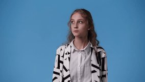4k video of one girl smiling over blue background.