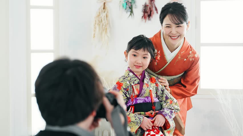 Mother and daughter in Japanese kimono. Commemorative photo in Japanese clothes. Photo studio. Royalty-Free Stock Footage #1103596397