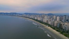 Aerial cityscape of coast bay. Drone view of the beach and buildings of the city.